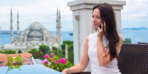Young Ukrainian woman sitting on the terrace with a stunning view of the city